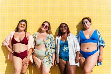 Group of beautiful plus size women with swimwear bonding and having fun at the beach - Group of...