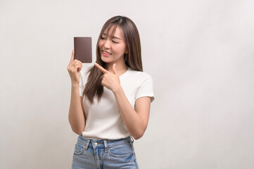 Young happy asian tourist woman over white background studio, travel and holidays concept..