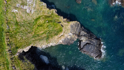 Grassy cliffs on the Atlantic Ocean coast. Landscape of Ireland from a height. Seaside rocks. Drone point of view. View from above.