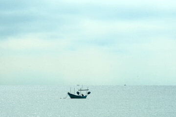 Calm sea with a boat scenery in Kijal, Kemaman, Terengganu, Malaysia.