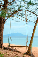 A swing by calm coastal scenery in Kijal, Kemaman, Terengganu, Malaysia.