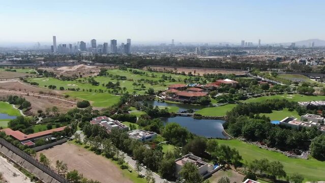 Aerial view of the golf course. Setting up a drone shot hovering over a golf club. Early morning, summer, sunlight