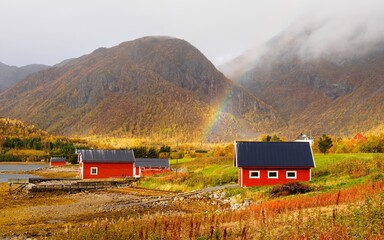 Beautiful Norwegian landscape with a traditional houses and cloudy sky.Norwegian fjord. - obrazy, fototapety, plakaty