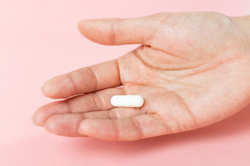 Tablet in hand, vitamin supplementation, healthy lifestyle, immunity support, mental and physical...