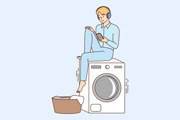 Smiling guy listen to music wait for laundry