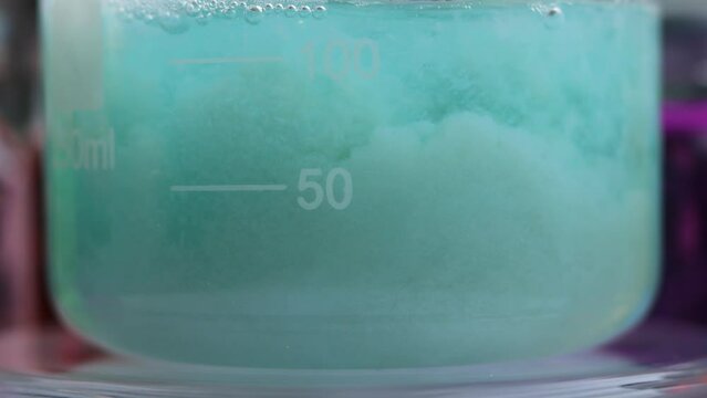 The chemical reaction of the formation of a large amount of a mixture insoluble silicates of copper, manganese and zinc, in a beaker.