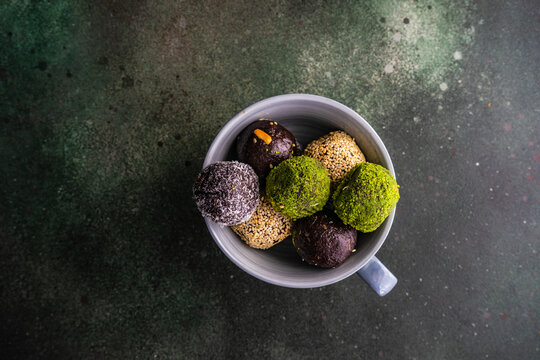 Overhead view of assorted  pakhlava balls in a cup