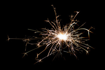 Burning sparkler isolated on black background. Fireworks theme. Light effect and texture.