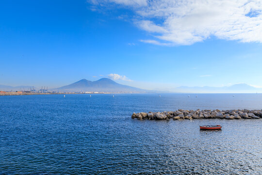 Cityscape of Naples from the waterfront: view of the Gulf of Naples with Vesuvius in the background.