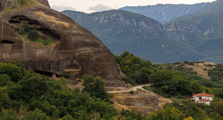 Obraz premium Stunning mountain panorama. Meteora Kastraki Greece. Hermit caves. Travel, hiking, vacation. Famous Greek orthodox christian shrine, unique rock formation, Unesco world heritage site.