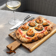 Italian focaccia with shrimps and zucchini with cherry tomatoes.