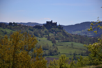 Le Puy-en-Velay, France - May 5th 2019 : The Château de Bouzols, an old fortified castle, whose origins date back to the 9th century. It's a stone castle that looks like a dark fortress in nature.