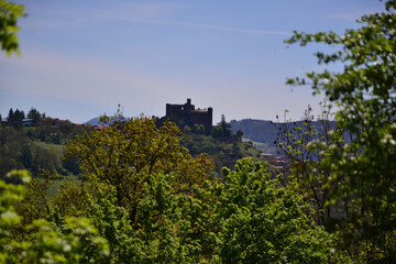 Fototapeta na wymiar Le Puy-en-Velay, France - May 5th 2019 : The Château de Bouzols, an old fortified castle, whose origins date back to the 9th century. It's a stone castle that looks like a dark fortress in nature.