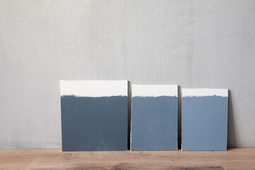 Color samplers at blank plaster wall interior renovation concept