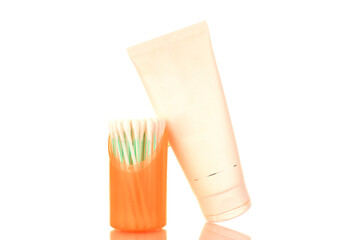 One plastic container for cosmetics and ear sticks in plastic container, macro, isolated on white background.