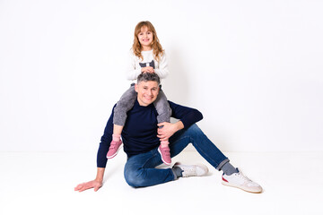 Daughter and father having fun on studio portrait