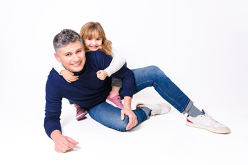 Fototapeta na wymiar Daughter and father having fun on studio portrait