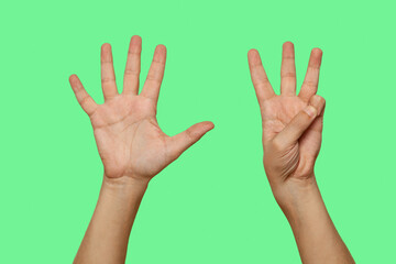 Hands showing number 8 isolated on green screen background..