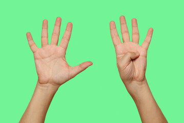 Hands showing number 9 isolated on green screen background..