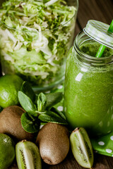 From above view of green smoothie with fruit and vegetables on wood rustic table. selective focus
