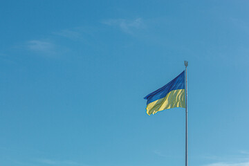 Ukrainian flag against the blue sky