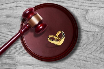 Law concept. Judge wooden gavel and rings on board