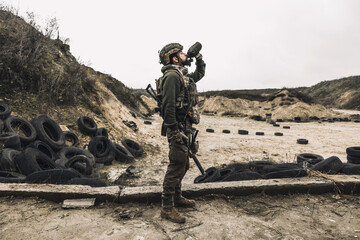 Soldier in military uniform drinking from flask