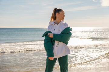 A young athletic girl against the backdrop of the sea