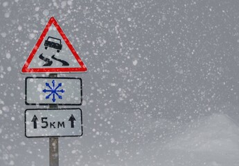 road sign warns of ice and snow at winter .