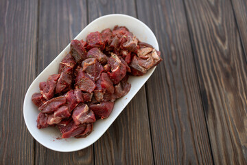Diced and pickled raw boar meat in spices, open space - obrazy, fototapety, plakaty