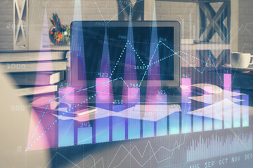 Financial chart drawing and table with computer on background. Multi exposure. Concept of international markets.