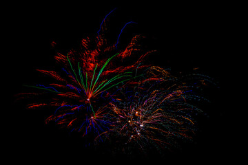 Fireworks on black sky in New Year midnight