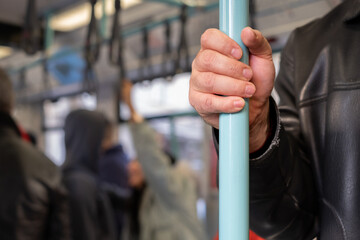 Close-up Man Hand 
Holding Handrail Inside the Train or Bus, Copy Space.
