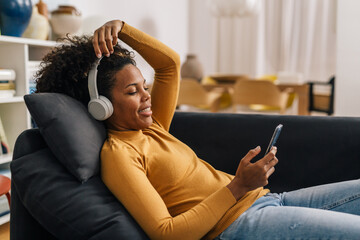Woman relaxes at home with music
