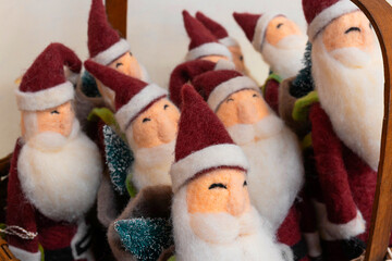 Santa Claus in a basket as a Christmas decoration. Happy Santas waiting for new homes at Christmastime.