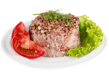 Canned buckwheat porridge with meat served on a plate with tomato and herbs