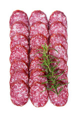 Raw smoked sausage cut into pieces, laid out in rows with rosemary