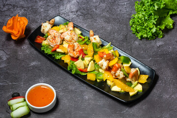 Shrimps salad with Orange, apple, cucumber, tomato and sauce served in dish isolated on grey background top view of indian and bangladesh food