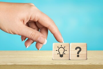 Question mark with lamp bulb on wooden cubes