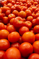 Big pile of tomatoes in a store.