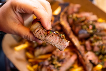 pieces of roast beef in the foreground t-bone