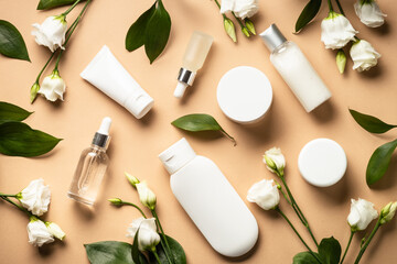 Natural cosmetic products. Cream, serum, tonic with green leaves and flowers. Skin care concept.