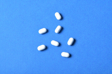 Top view of tic tac bonbons isolated on blue background