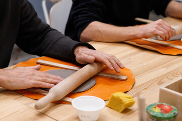 Male hands close-up. Master class clay modeling. Creative classes for adults and the elderly.