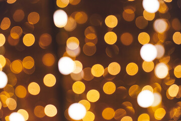 Abstract bokeh background burning light bulbs evening city and garlands.