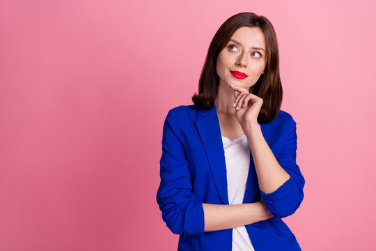 Photo of young intelligent businesswoman wear stylish blue formal outfit touch chin look interested empty space isolated on pink color background