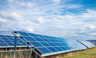 Solar power panel on blue sky background, alternative clean green energy concepts.