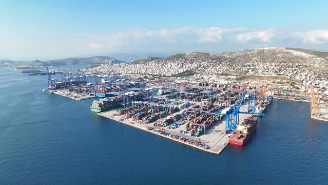 Aerial drone video of industrial container logistics unloading import and export container terminal of Perama - Piraeus, Attica, Greece
