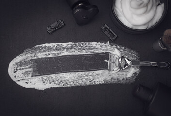 A set of items for shaving a beard on a black background.