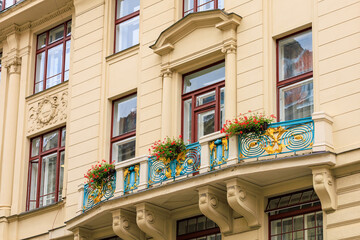 Fototapeta premium Facade of the house of classical European architecture of the old cozy tourist city. Background